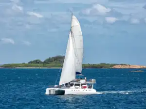 Private catamaran sailing at sunset off the coast of Weligama